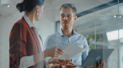 Man and woman discussing report in office